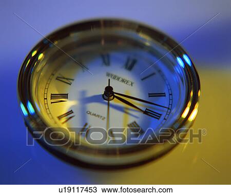Stock Image - Close up of an analog clock having roman numbers. Fotosearch