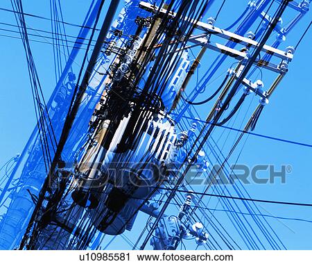Stock Image - Low angle view of large group of transmission lines. Fotosearch