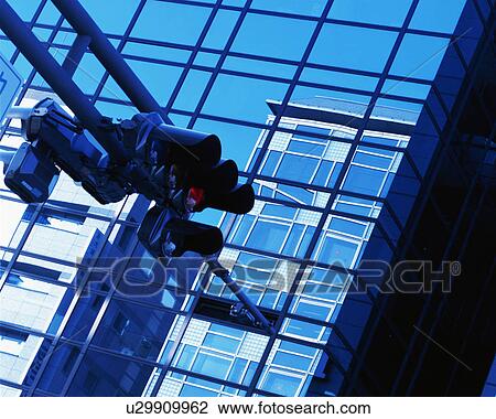 Low angle view of traffic signals and glass building View Large Photo Image Stock Image - Low angle view of traffic signals and glass building. Fotosearch