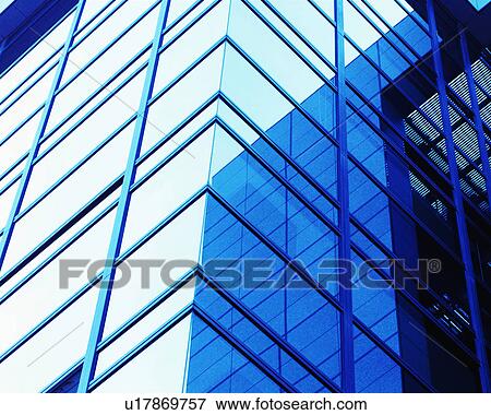 Stock Photo - Sky and buildings reflected into the glass building during the day. Fotosearch