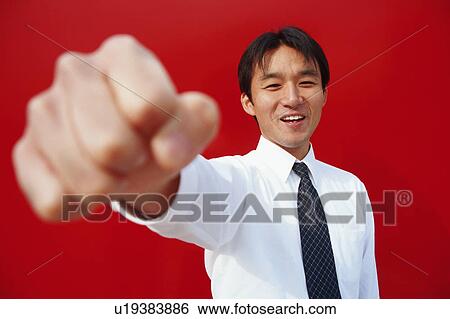 Stock Photograph - A man punching in front of a camera. Fotosearch