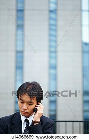 Stock Photo - A man talking on cell phone. Fotosearch
