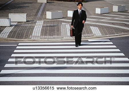 A man walking on zebra crossing View Large Photo Image Stock Photography - A man walking on zebra crossing. Fotosearch