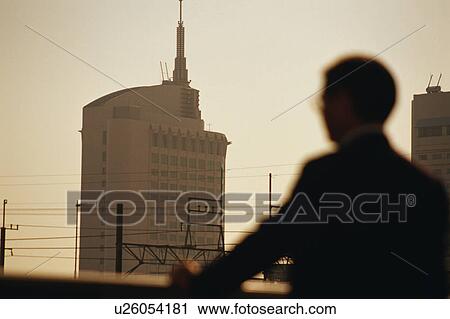 Blurred view of a mature man staring at office building View Large Photo Image Stock Image - Blurred view of a mature man staring at office building. Fotosearch