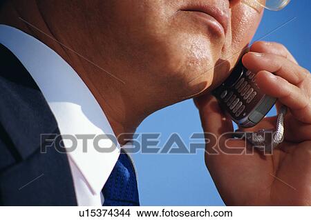 Close up of a mature man talking on cell phone View Large Photo Image Picture - Close up of a mature man talking on cell phone. Fotosearch