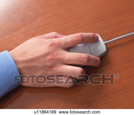 Stock Photo - Close-up of a person's hand holding computer mouse. Fotosearch
