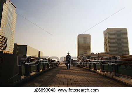 Front view of a mature man in suit with commercial buildings at the back View Large Photo Image Stock Image - Front view of a mature man in suit with commercial buildings at the back. Fotosearch