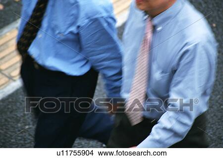 Picture - High angle view of two men in formal clothes walking together. Fotosearch