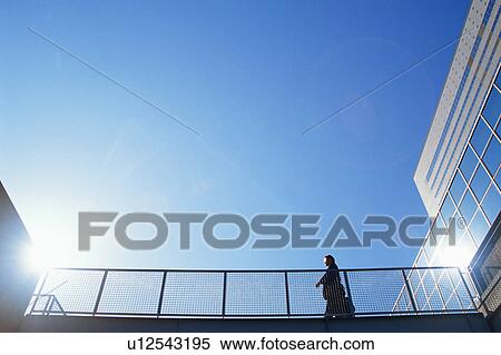Low angle view of a mature man walking near railing View Large Photo Image Stock Photography - Low angle view of a mature man walking near railing. Fotosearch