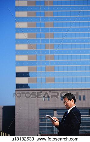 Stock Image - Side view of a mature man in suit . Fotosearch