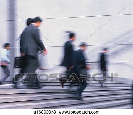 Small group of people in office wear walking down stairs View Large Photo Image Stock Photo - Small group of people in office wear walking down stairs. Fotosearch