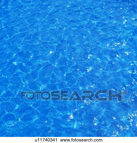 Stock Image - Placid water surface. Fotosearch