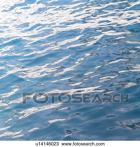 Stock Image - Placid water surface. Fotosearch