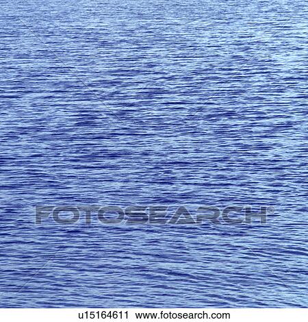 Stock Image - Placid water surface. Fotosearch
