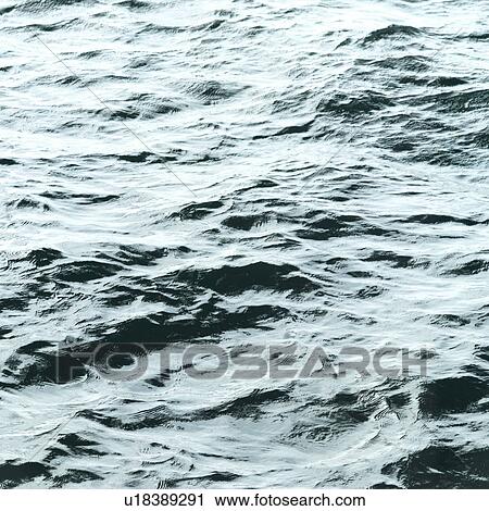 Stock Image - Placid water surface. Fotosearch