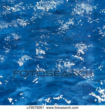 Stock Image - Placid water surface. Fotosearch