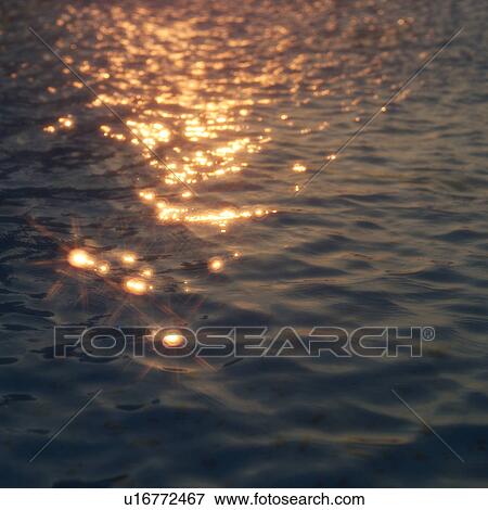Sunlight reflected on water surface View Large Photo Image Stock Photo - Sunlight reflected on water surface. Fotosearch