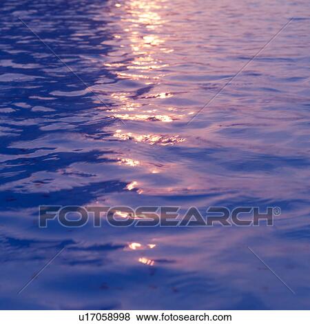 Stock Photo - Sunlight reflected on water surface. Fotosearch