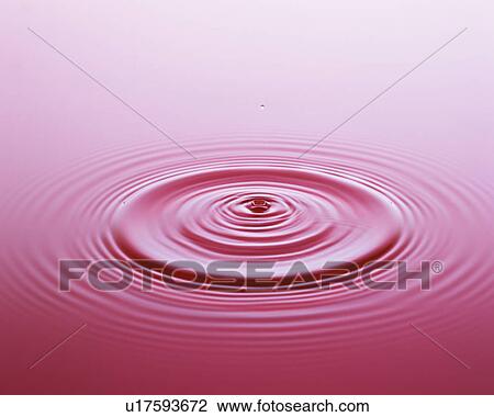 Stock Image - Water droplet falling on surface of water . Fotosearch