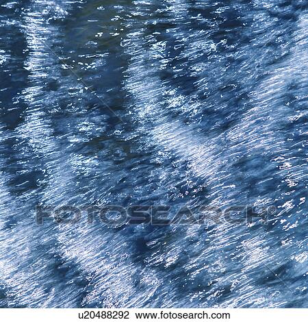 Stock Image - Water flowing rapidly in stream. Fotosearch