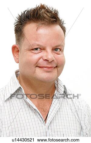 Stock Image - Overweight man smiling, portrait. Fotosearch