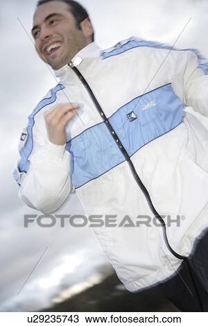 Young man jogging in spite of bad weather View Large Photo Image Stock Image - Young man jogging in spite of bad weather. Fotosearch