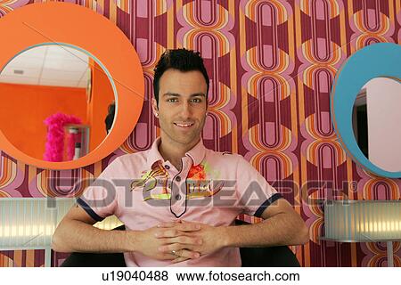 Young man sitting in hairdresser's shop in seventies style View Large Photo Image Stock Photo - Young man sitting in hairdresser's shop in seventies style. Fotosearch