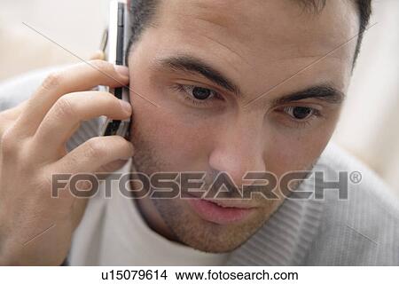 Picture - Young man using cell phone, portrait. Fotosearch