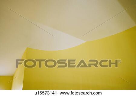 Stock Image - Architectural details of ceiling and yellow walls. Fotosearch