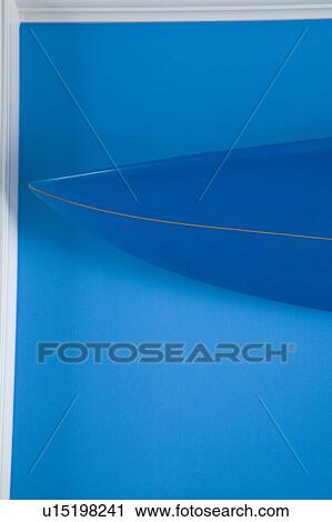 Stock Image - Blue surfboard mounted on wall. Fotosearch