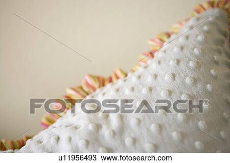 Stock Image - Detail of throw pillow with fringe. Fotosearch