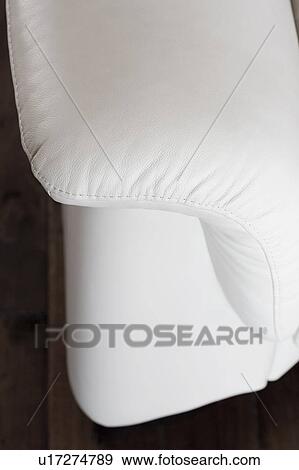 Stock Photo - Detail of white leather couch arm. Fotosearch