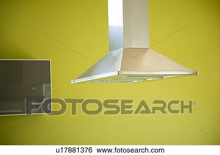 Overhead stove top fan and green wall in modern kitchen View Large Photo Image Stock Photograph - Overhead stove top fan and green wall in modern kitchen. Fotosearch