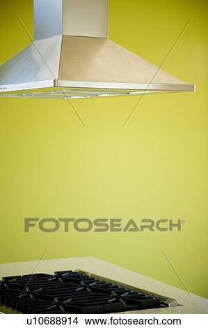 Picture - Overhead Stovetop Fan and Green Wall in Modern Kitchen. Fotosearch