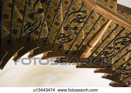 Traditional And Elegant Stairway With Wrought Iron And Wood