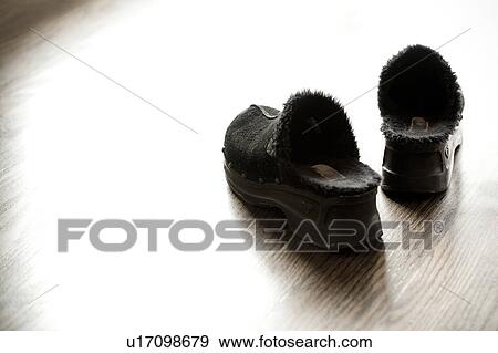 Black slippers on hardwood floor View Large Photo Image Stock Photo - Black slippers on hardwood floor. Fotosearch