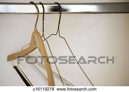 Empty hangers on rod View Large Photo Image Stock Photo - Empty hangers on rod. Fotosearch