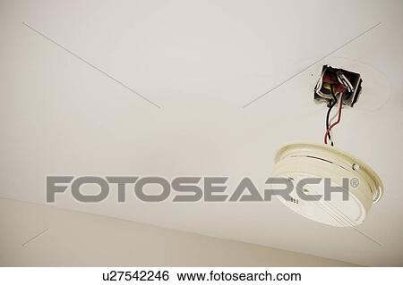 Stock Photograph - Hanging smoke detector. Fotosearch