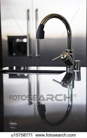 Modern water faucet with reflection View Large Photo Image Stock Image - Modern water faucet with reflection. Fotosearch