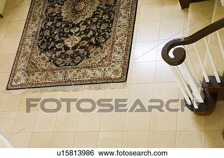 Stock Photograph - Rug and banister in foyer. Fotosearch