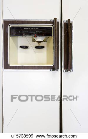 Stock Photo - Water and ice dispenser on a retro refrigerator. Fotosearch