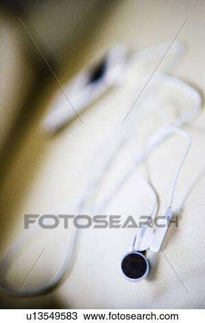 Stock Image - White MP3 Player on White Leather Armchair. Fotosearch