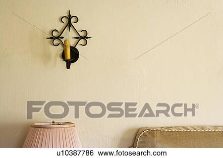 Stock Photograph - Wrought iron wall sconce with candle. Fotosearch