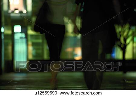 Stock Image - The couple on the street at night. Fotosearch