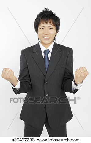 Stock Image - Business lady clenching fists in triumph. Fotosearch