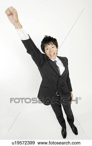 Businessman clenching fist in triumph View Large Photo Image Stock Photo - Businessman clenching fist in triumph. Fotosearch