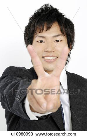 Stock Image - Businessman doing peace sign. Fotosearch