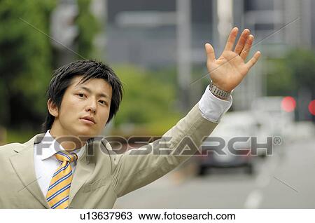 Businessman hailing a taxi View Large Photo Image Stock Image - Businessman hailing a taxi. Fotosearch