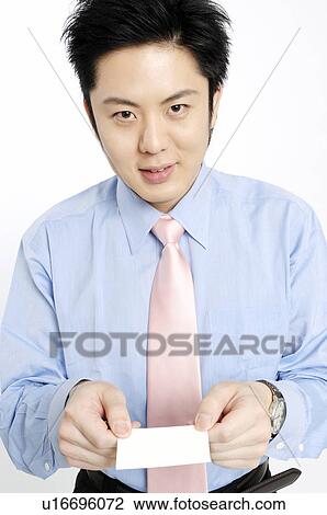 Businessman holding out a business card View Large Photo Image Stock Image - Businessman holding out a business card. Fotosearch