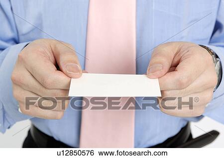Stock Photograph - Businessman holding out a business card. Fotosearch